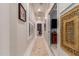 Long hallway with a built-in shelving unit and decorative wall art at 1075 W Desert Aster Rd, San Tan Valley, AZ 85143