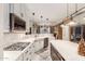 Modern kitchen with stainless steel appliances, large island, and stylish pendant lighting at 1075 W Desert Aster Rd, San Tan Valley, AZ 85143