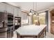 Modern kitchen with stainless steel appliances and a large kitchen island at 1075 W Desert Aster Rd, San Tan Valley, AZ 85143