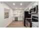 Bright kitchen showcasing white cabinets, stainless steel appliances, and a tile backsplash for a clean, modern aesthetic at 11440 N Hagen Dr, Sun City, AZ 85351