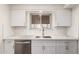 Kitchen with white cabinets, stainless steel appliances, and a window offering natural light for a cheerful cooking experience at 11440 N Hagen Dr, Sun City, AZ 85351