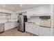 Modern kitchen with stainless steel appliances and white shaker cabinets at 11440 N Hagen Dr, Sun City, AZ 85351