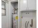 Interior laundry room with water heater and cabinets at 11440 N Hagen Dr, Sun City, AZ 85351