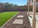 Artificial turf lawn, gravel landscaping, and covered patio at 11621 W Cheryl Dr, Youngtown, AZ 85363