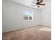 Well-lit bedroom with carpeted floor and ceiling fan at 11621 W Cheryl Dr, Youngtown, AZ 85363