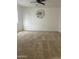 Carpeted bedroom with ceiling fan and neutral decor at 11621 W Cheryl Dr, Youngtown, AZ 85363