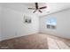 Bright bedroom with carpeted floor and ceiling fan at 11621 W Cheryl Dr, Youngtown, AZ 85363