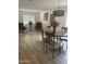 Elegant dining room featuring hardwood floors and modern light fixture at 11621 W Cheryl Dr, Youngtown, AZ 85363