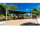 Community playground with shaded play area and picnic tables at 11621 W Cheryl Dr, Youngtown, AZ 85363