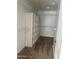 Large walk-in closet with shelving and carpeting at 11621 W Cheryl Dr, Youngtown, AZ 85363