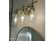 Three-light gold vanity fixture with glass shades at 1223 E Villa Rita Dr, Phoenix, AZ 85022