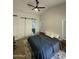 Main bedroom with barn door, ceiling fan, and ensuite bathroom at 1223 E Villa Rita Dr, Phoenix, AZ 85022