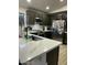 Modern kitchen with quartz countertops and dark cabinetry at 1223 E Villa Rita Dr, Phoenix, AZ 85022