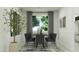 Modern dining room with black chairs and a dark wood table at 12517 W Trumbull Rd, Avondale, AZ 85323