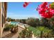 Landscaped backyard with pool, cacti, and vibrant flowers at 12605 E Kalil Dr, Scottsdale, AZ 85259