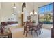 Bright dining room with a large table, chandelier, and views to the backyard at 12605 E Kalil Dr, Scottsdale, AZ 85259