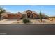 Beautiful desert landscape surrounds this two-story home with a three-car garage at 12605 E Kalil Dr, Scottsdale, AZ 85259