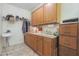 Laundry room with sink, cabinets, and additional storage at 12605 E Kalil Dr, Scottsdale, AZ 85259