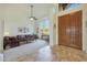 Living room with tiled floors, plush sofas, and a high ceiling at 12605 E Kalil Dr, Scottsdale, AZ 85259