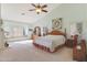 Main bedroom with carpeted floor, king-size bed, and window seat at 12605 E Kalil Dr, Scottsdale, AZ 85259