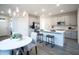 Modern dining area with white table and gray chairs at 13143 N 145Th Ln, Surprise, AZ 85379