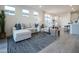 Living area with L-shaped sectional sofa, coffee table and view into dining area at 13143 N 145Th Ln, Surprise, AZ 85379