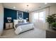 Main bedroom with a navy feature wall, king-size bed, and a chandelier at 13143 N 145Th Ln, Surprise, AZ 85379