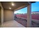 Covered patio with view of backyard and brick wall at 13143 N 145Th Ln, Surprise, AZ 85379