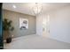 Bright bedroom with access to bathroom, neutral walls, and modern chandelier at 13171 N 145Th Ln, Surprise, AZ 85379