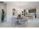 Open concept dining area with modern glass table and chairs at 13171 N 145Th Ln, Surprise, AZ 85379