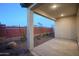 Covered patio with brick wall and desert landscaping at 13171 N 145Th Ln, Surprise, AZ 85379