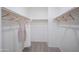 Spacious walk-in closet with wood shelving and hanging rods at 13183 N 145Th Ln, Surprise, AZ 85379