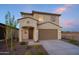 Two-story house with brown garage door and landscaping at 13183 N 145Th Ln, Surprise, AZ 85379