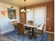 Dining area with wooden table and chairs, view into kitchen at 13227 N Mimosa Dr # 117, Fountain Hills, AZ 85268