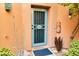 Front door with security gate, surrounded by desert plants at 13227 N Mimosa Dr # 117, Fountain Hills, AZ 85268