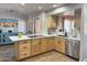 Open kitchen with light wood cabinets, an island, and a stylish backsplash at 13227 N Mimosa Dr # 117, Fountain Hills, AZ 85268