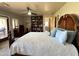 Main bedroom with king-size bed, private balcony, and built-in shelving at 13227 N Mimosa Dr # 117, Fountain Hills, AZ 85268