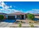 Single-story home with a two-car garage and landscaped yard at 14114 W Smoketree Dr, Surprise, AZ 85387