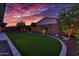 Landscaped backyard with artificial turf and a curved border at 14114 W Smoketree Dr, Surprise, AZ 85387