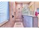 Spa-like bathroom with walk-in shower, glass block feature, and bench at 14114 W Smoketree Dr, Surprise, AZ 85387