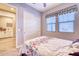 Well-lit bedroom with sliding door to closet and neutral bedding at 14114 W Smoketree Dr, Surprise, AZ 85387