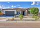 Single story home with a two-car garage and well-manicured landscaping at 14114 W Smoketree Dr, Surprise, AZ 85387