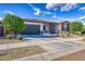 Single-story home with a two-car garage and landscaped front yard at 14114 W Smoketree Dr, Surprise, AZ 85387