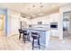 Modern kitchen with white cabinets, an island, and stainless steel appliances at 14114 W Smoketree Dr, Surprise, AZ 85387