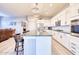 Modern kitchen with white cabinets, large island, and stainless steel appliances at 14114 W Smoketree Dr, Surprise, AZ 85387