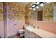 Retro bathroom with pink tile, a vanity, and patterned wallpaper at 148 E Coronado Rd # 45, Phoenix, AZ 85004