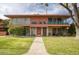 Mid-century modern building with two levels, balconies, and a manicured lawn at 148 E Coronado Rd # 45, Phoenix, AZ 85004