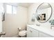 Bathroom with a vanity, toilet, and round mirror at 1531 W Colter St # 7, Phoenix, AZ 85015