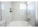 Updated bathroom with marble tile, shower, and bathtub at 1531 W Colter St # 7, Phoenix, AZ 85015