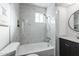 Modern bathroom with marble tile, bathtub, and updated vanity at 1531 W Colter St # 7, Phoenix, AZ 85015